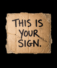“This Is Your Sign” Handwritten Cardboard Placard